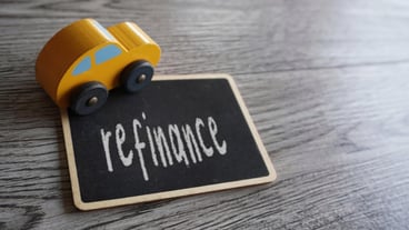 Toy car and text REFINANCE with copy space Car loan refinancing concept