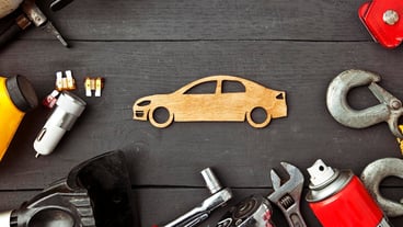 A lot of different car accessories and equipment on the wooden table