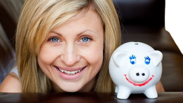 Portrait of a beautiful woman with a piggy bank