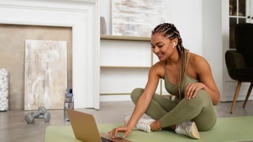 Full shot woman training with laptop