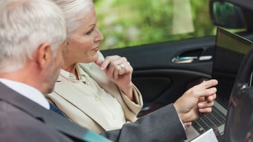 Business people work together in a chic convertible.