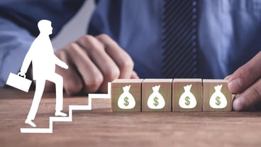 Businessman walking up to money bag