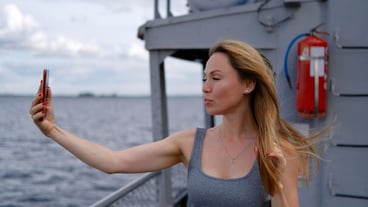 Beautiful white woman make selfie on a ferry boat