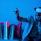 Caucasian man with vr glass choosing program while sitting at sofa deviation