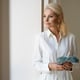 Portrait of middle-aged blonde rich woman with cash money