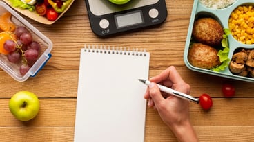 Top view tasty meal arrangement with empty notebook