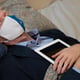 Midsection of doctor examining patient at home