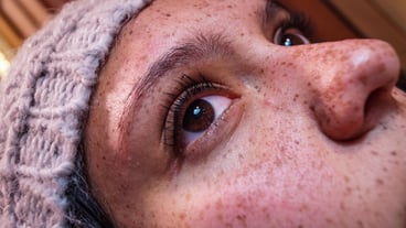 Close-up of a teenage girl with freckles on her face
