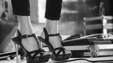 Low section of fashionable woman wearing stilettos