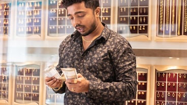 Man counting banknotes in jewelry store