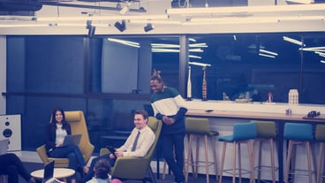 Multiethnic startup business team on meeting in modern bright office interior brainstorming, working on laptop and tablet computer