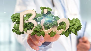 Handle holding the wooden logo bio with leaves around reproduction 3d