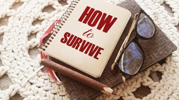 How to survive words on cover of copybook glasses and pen Surcvival concept Crisis management business concept Coronavirus prevention concept