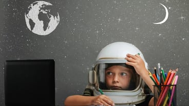 The child studies remotely at school, wearing an astronaut's helmet. back to school.  effects glitch