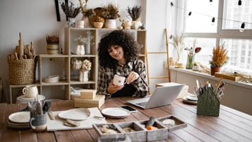 Female entrepreneur managing online order of mug on website