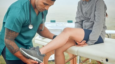 Any pain Cropped shot of a handsome young male physiotherapist working on a female patient outside