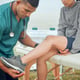 Any pain Cropped shot of a handsome young male physiotherapist working on a female patient outside