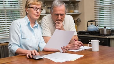 Senior couple working out their bills