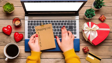 Girl with shopping list, debit card, gift selection, shopping, laptop, coffee mug