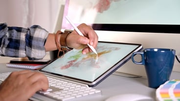 Graphic designer working with digital drawing tablet in the studio workplace.