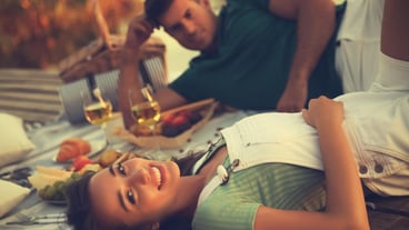 Happy couple spending time on pier at picnic
