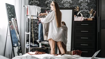 Online resale consignment and thrift store buy and sell secondhand clothes young woman decluttering