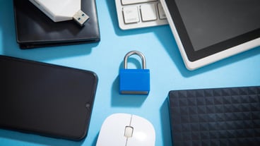 Padlock with a tablet keyboard mouse and other device Internet and technology security