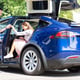 Helpful loving husband. Helpful loving husband giving hand to his appealing stylish wife leaving car
