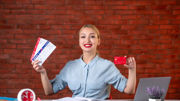 Front view of travel agent holding tickets and red credit card assistant global occupation agency money job professional working managers map