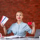 Front view of travel agent holding tickets and red credit card assistant global occupation agency money job professional working managers map