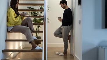 Young man using mobile phone while sitting on seat