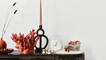 Elegant living room composition with console, candlestick, gemstone and stylish personal accessories. Copy space. Template.