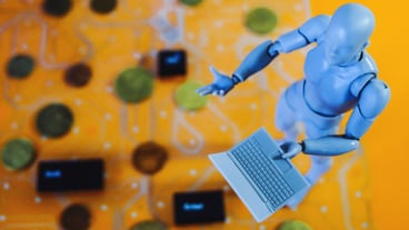 High angle view of figurine with laptop on table