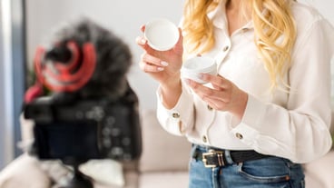 Close-up woman holding cream container