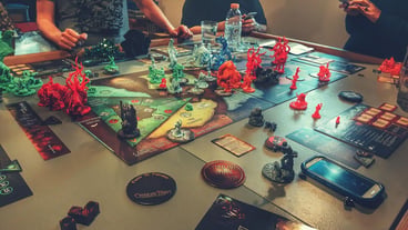 Midsection of people playing board game