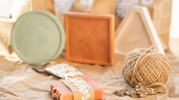 DIY soap with aromas of herbs and flowers on craft paper background