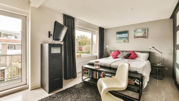 A bedroom with a bed and a tv