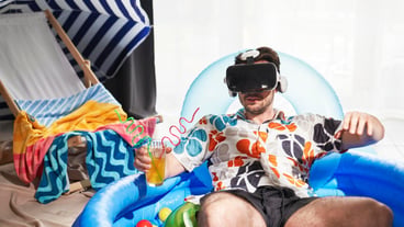 Man with VR glasses sitting in an inflatable ball pool