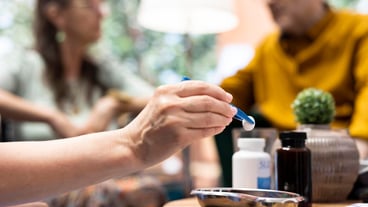Professional nurse separating pills and medicine in two different bottles