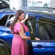 Elegant and overweight woman buying an SUV car at a car dealership