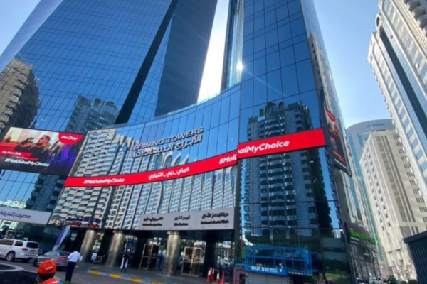 Outdoor LED screen mounted on a skyscraper facade in a city building