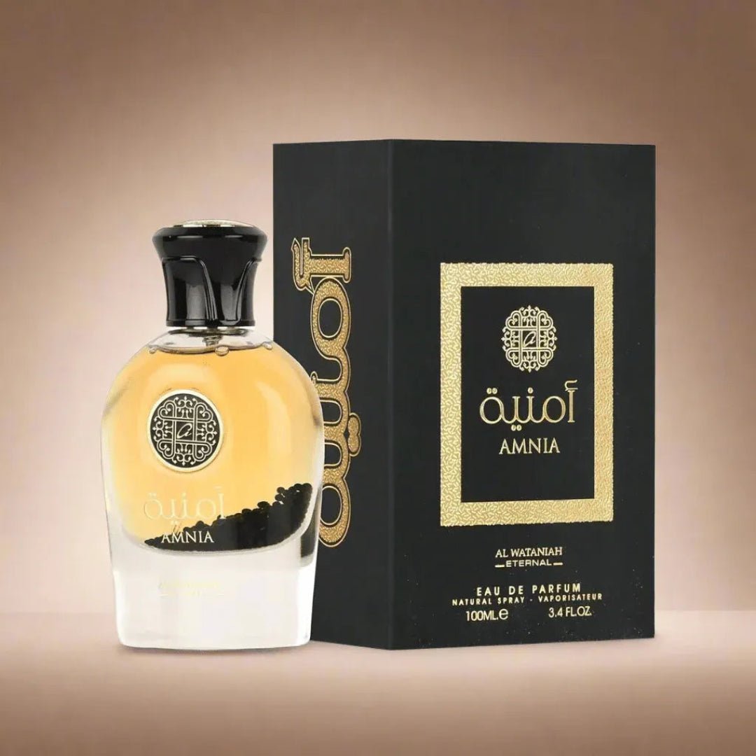 Amnia perfume bottle and packaging on a beige background