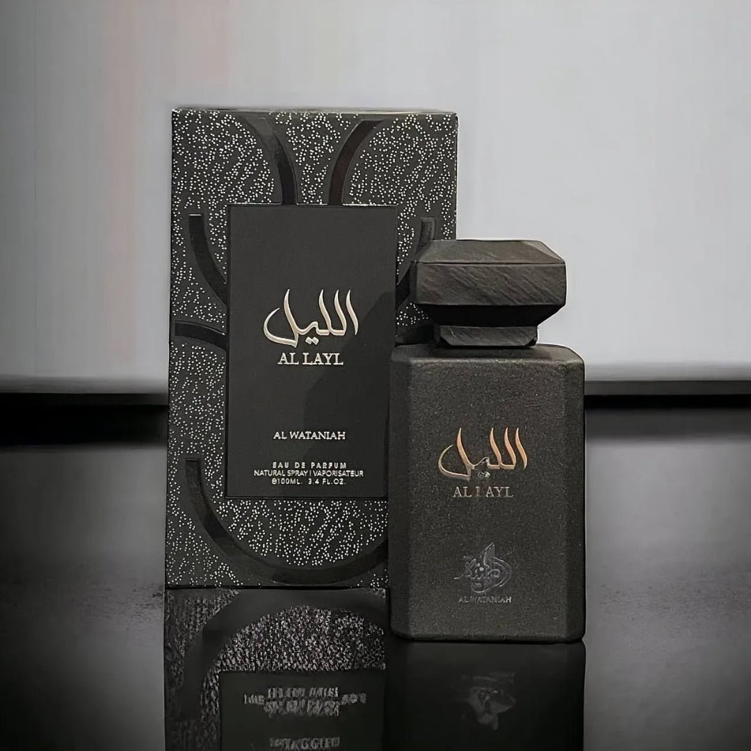 Black perfume bottle and packaging with 'Al Layl' branding on a reflective surface.