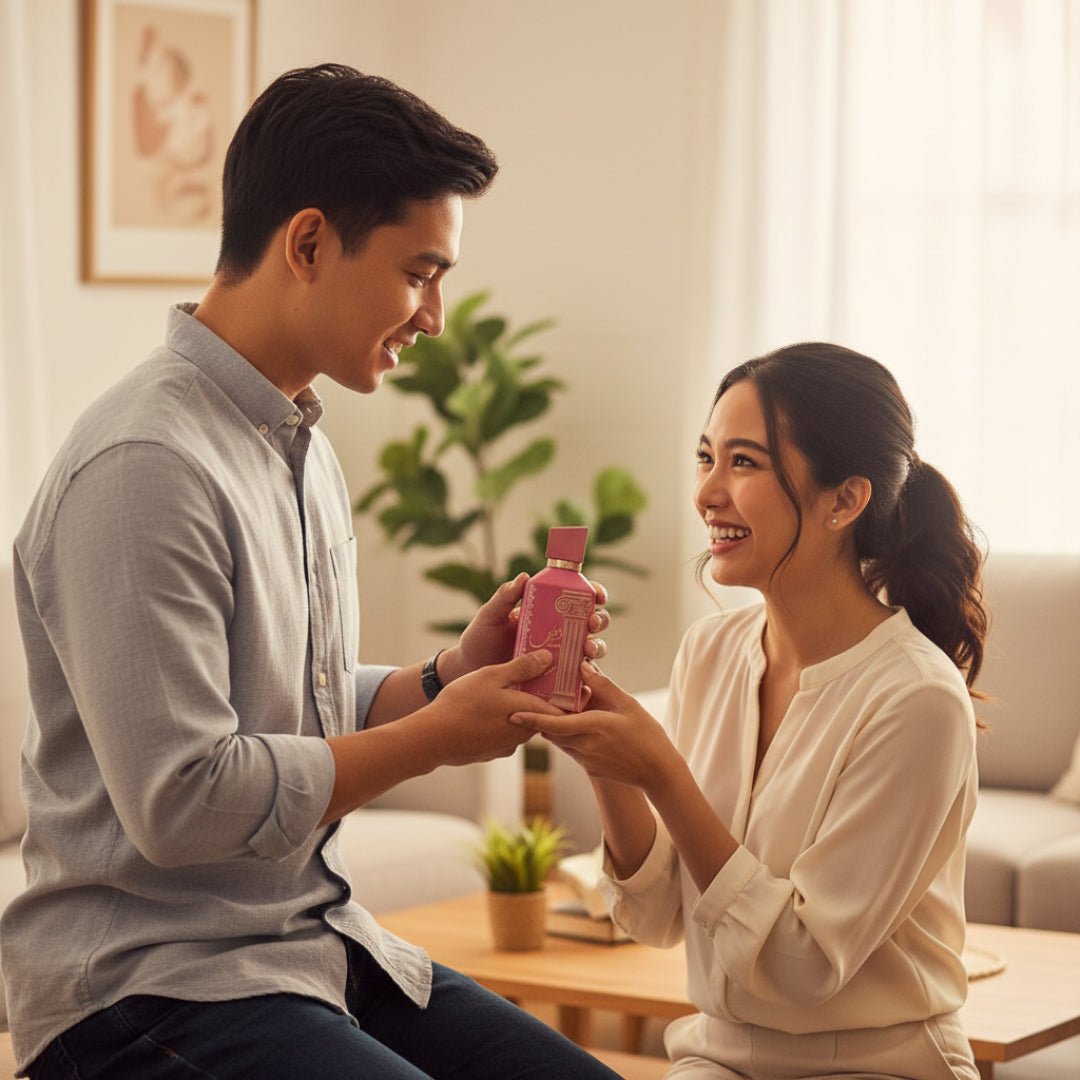Pink perfume bottle and packaging with decorative elements on a white background