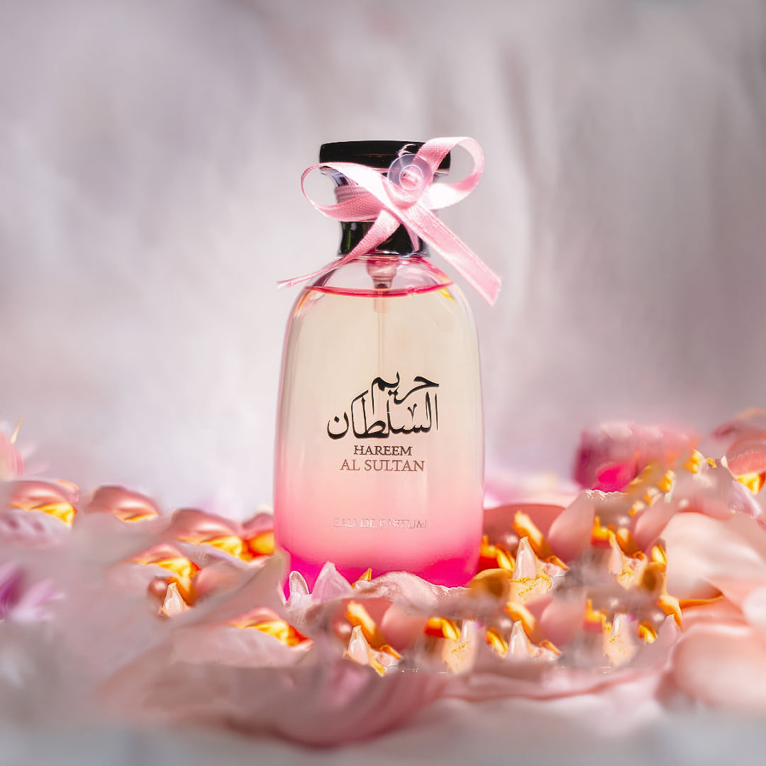 Hareem Al Sultan 100 ml EDP &ndash; Perfume bottle with pink ribbon on a soft, blurred background