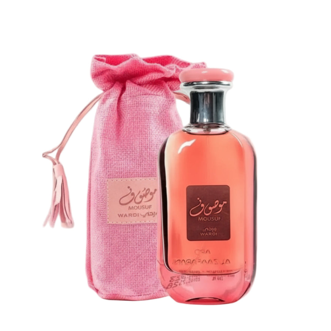 Perfume bottle with pink drawstring bag on a light surface