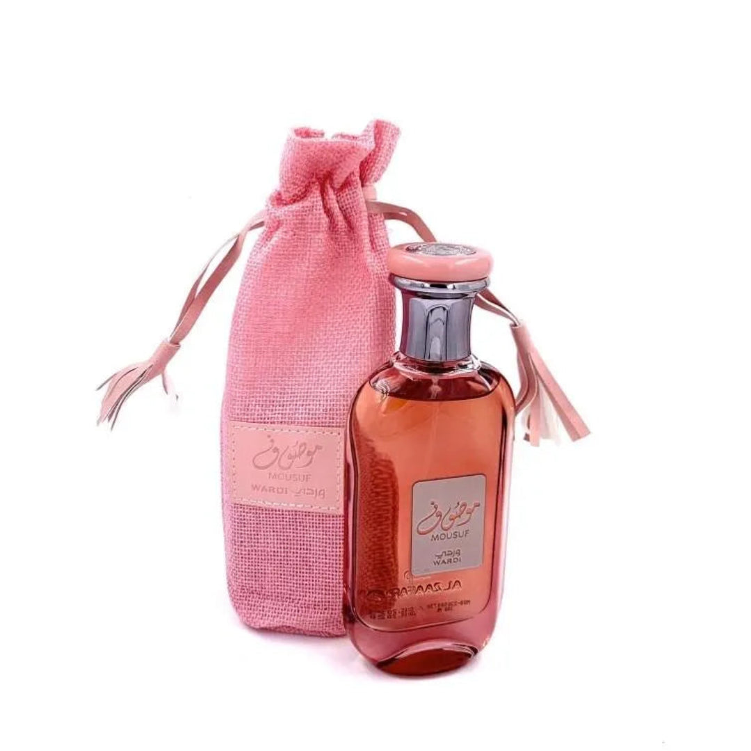 Perfume bottle with pink drawstring bag on a white background