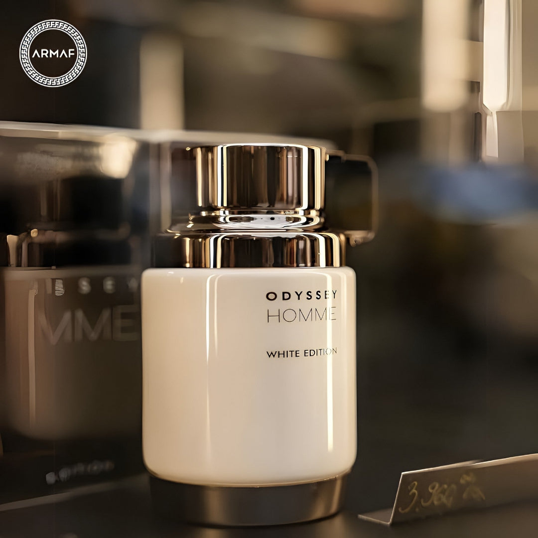 White and gold bottle of Odyssey Homme White Edition by Armaf on a blurred background