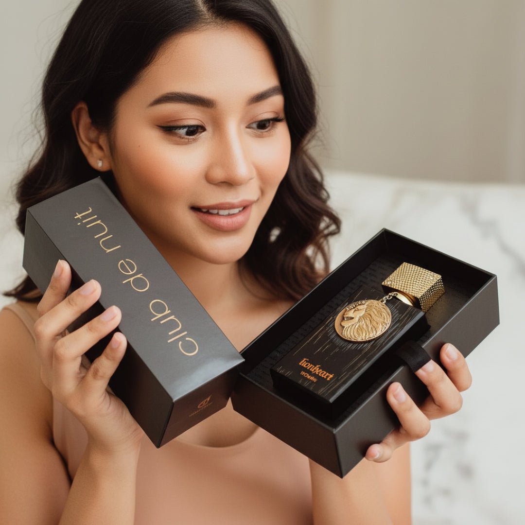 Woman holding a black box with a gold item inside, branded Club De Nuit Lionheart women