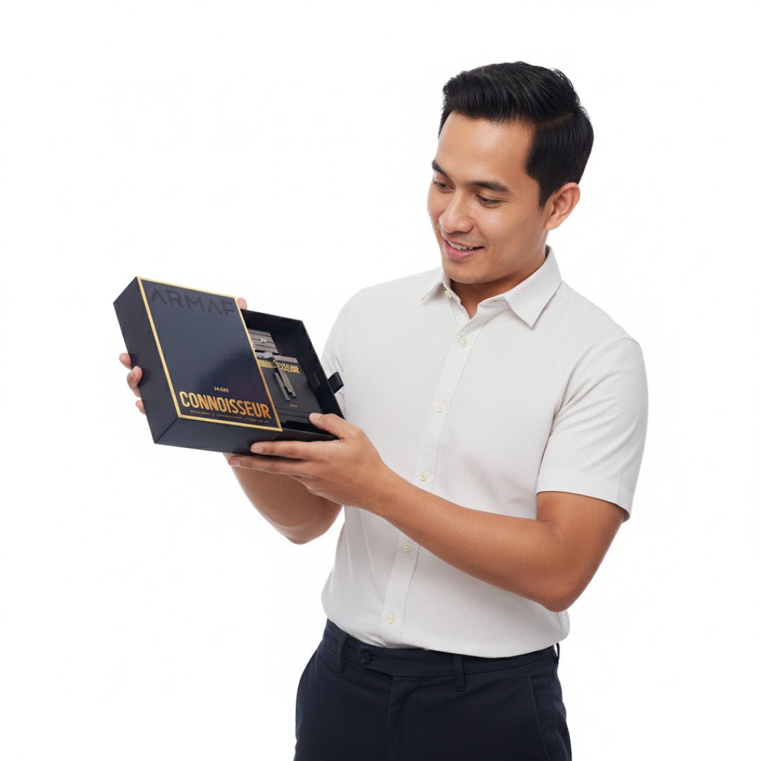 Man holding a black box with 'Connoisseur' branding on a white background